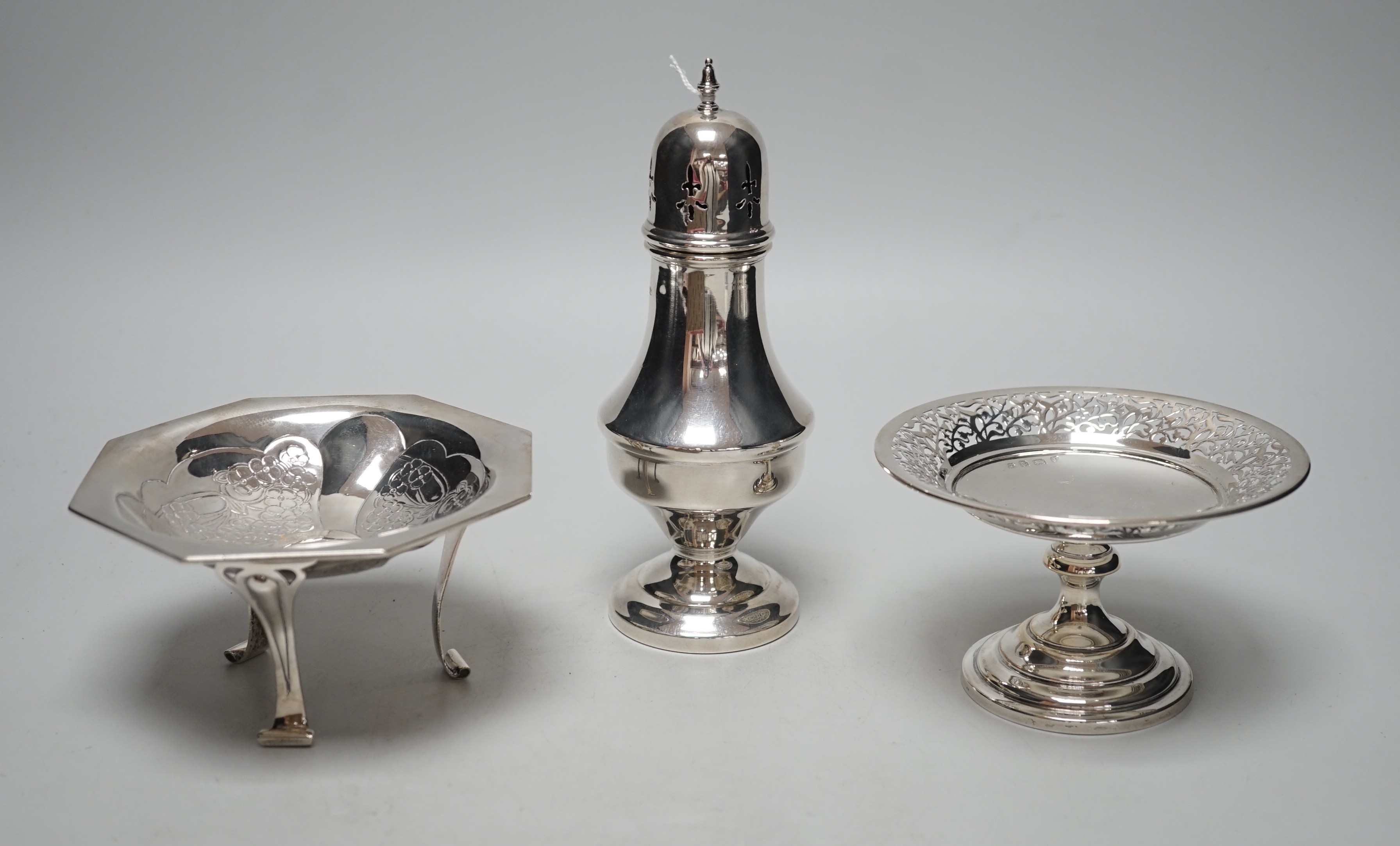 An Art Nouveau silver tripod bowl, by W.G. Connell, London, 1901, diameter 13cm, a later silver pedestal dish and modern silver sugar caster, 19cm, 11.4oz.